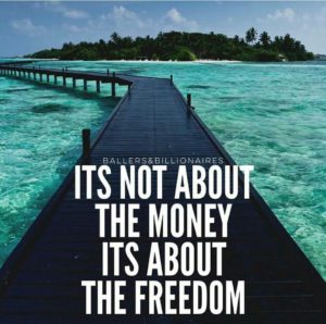 A picture of an ocean dock stretching out into the ocean of beautiful clear island water. The words, Its not about the money its about the freedom" are written on it.