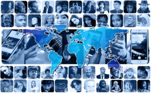 A picture of a World map, cell phones , and pictures of people form all races and backgrounds. Collaboration takes everybody.